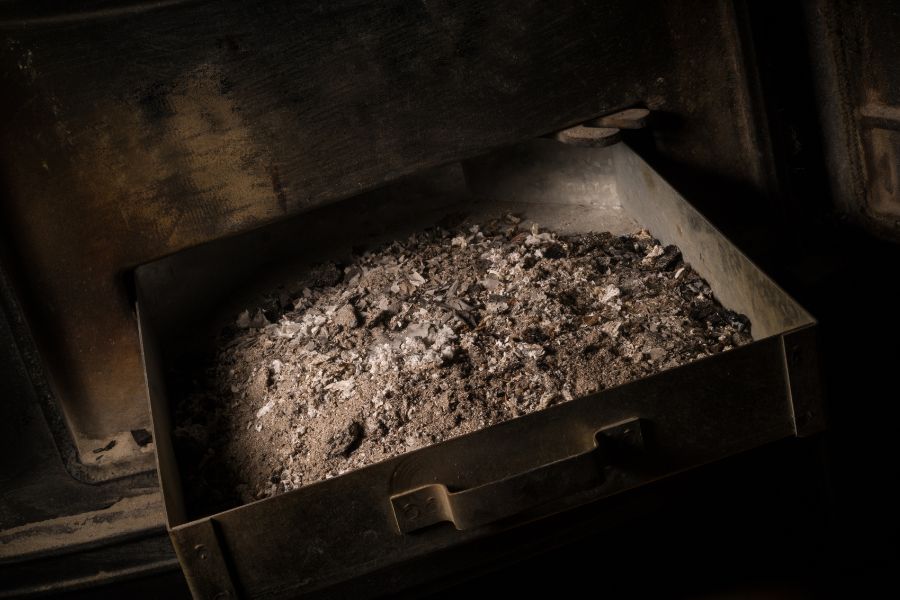 A full ash pan of a wood burning stove