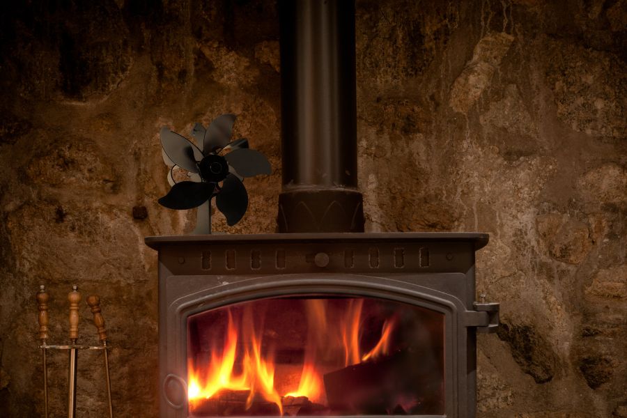 Heat powered fan on burning wood stove