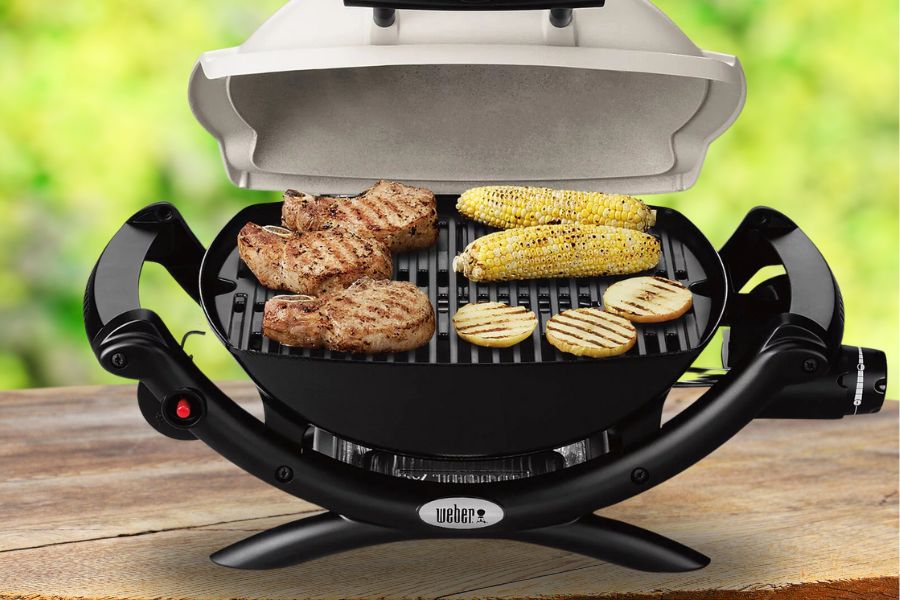 Weber Q1000 with grilled food on table