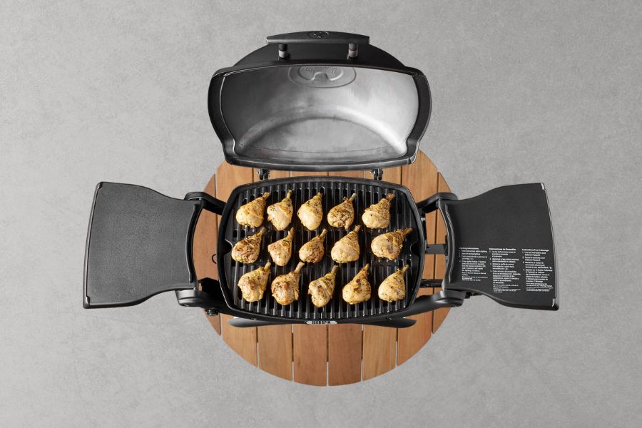 Top view of Weber Q1200 with grilled food on table