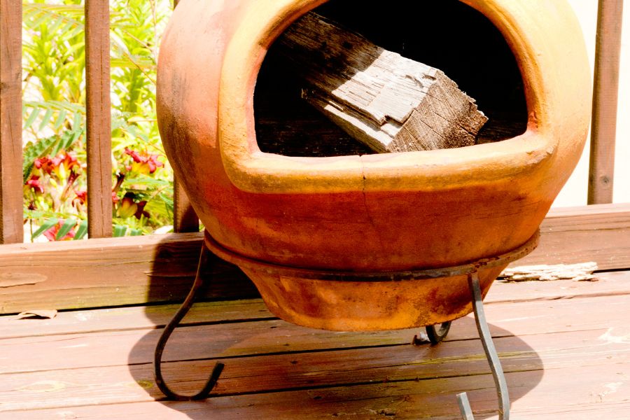 A chiminea on wooden deck in summer
