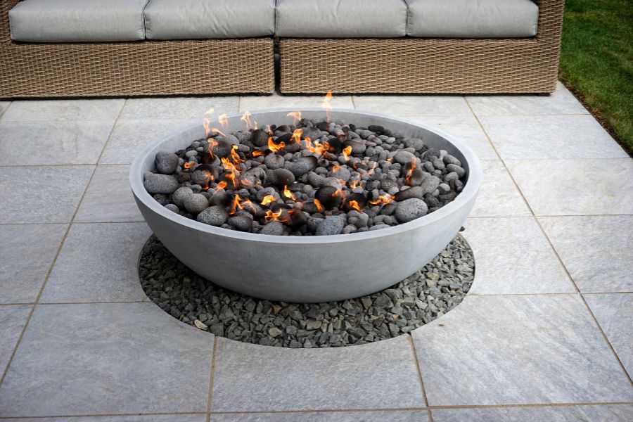 Propane fire pit with flame on patio