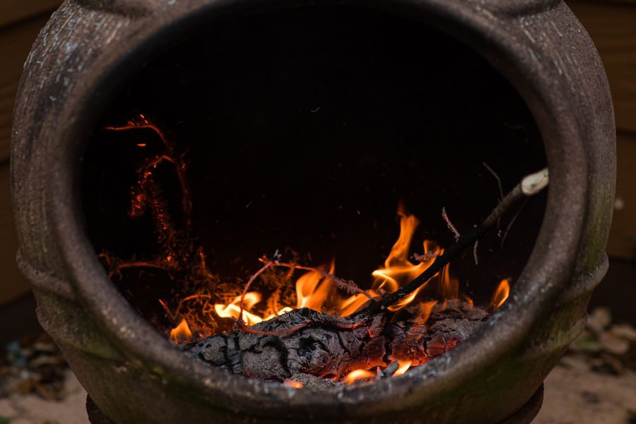 Wood burning in a rustic chiminea