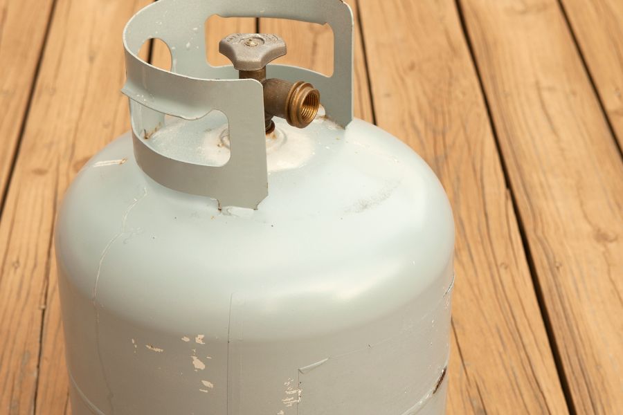 Propane tank on wooden surface