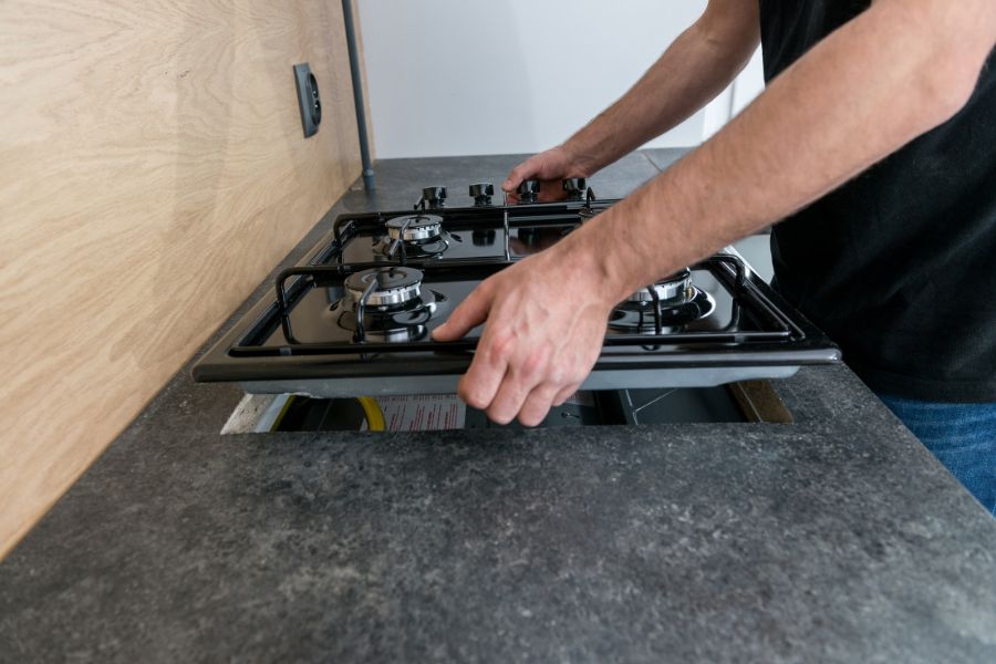 Professional installing new gas stove in the kitchen