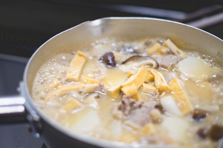 Food simmered in saucepan on stove