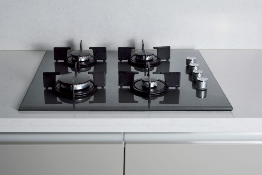 Modern black glass gas stove in the kitchen