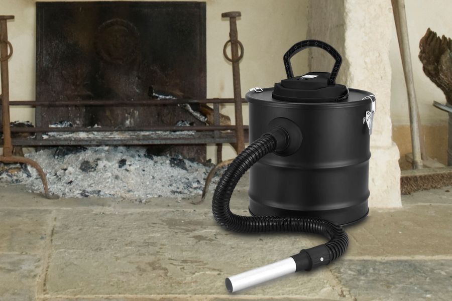 An ash vacuum next to fireplace with ash