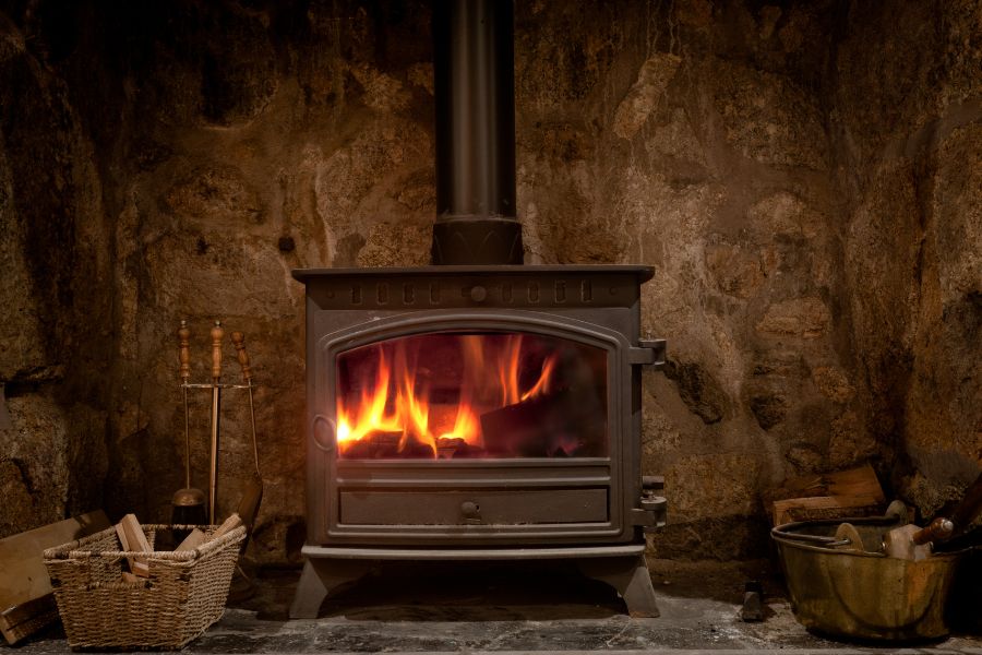 A cozy fireplace with wood burning stove