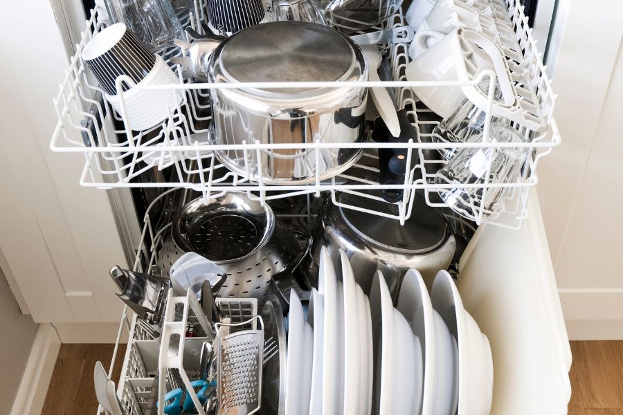 Cookware and utensils in the dishwasher in the kitchen