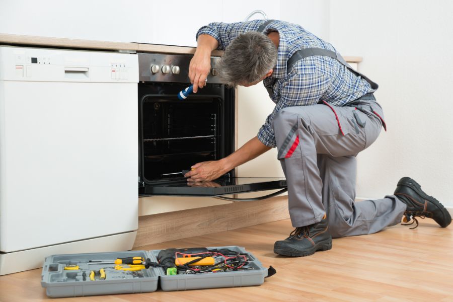 Electrician repairing electric oven