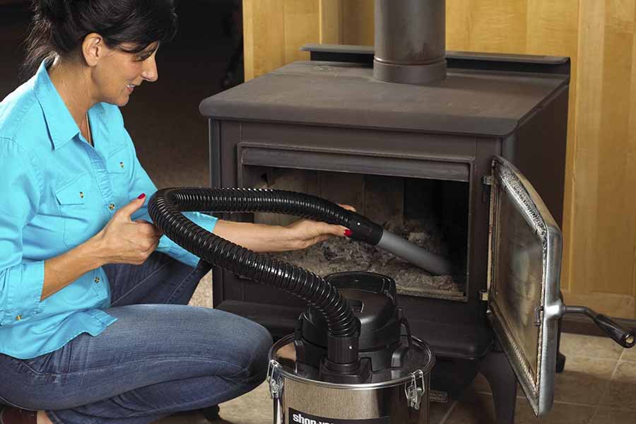 woman clean a wood-burning fireplace
