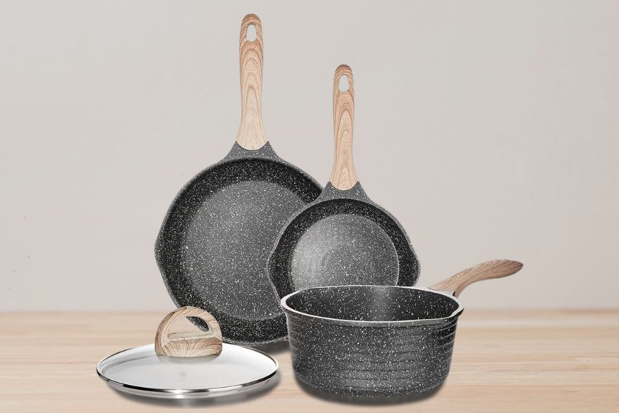 Set of granite cookware on table