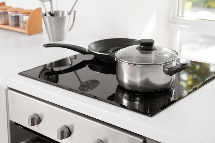 Electric stove with cookware in the kitchen