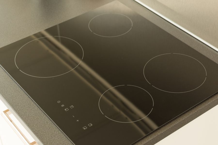 Modern induction cooktop on black countertop