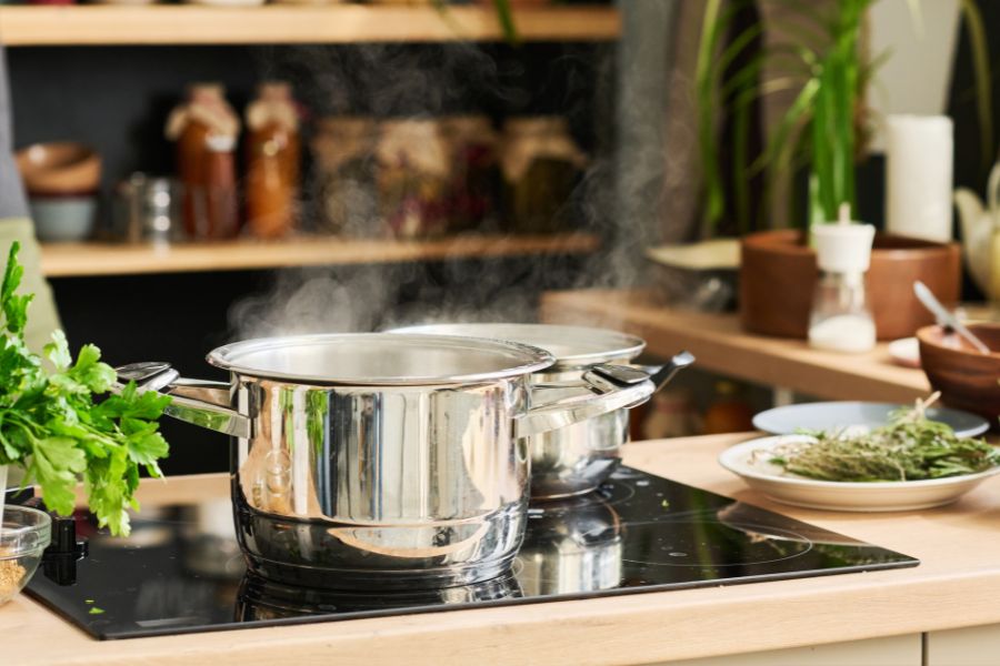 Boiling pot on electric stove in the kitchen