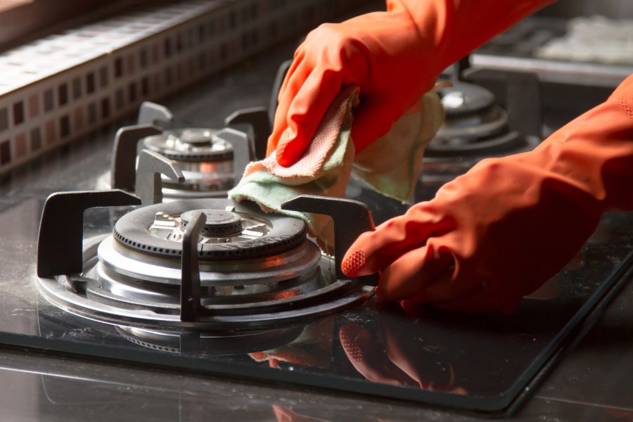 Cleaning gas stove in the kitchen